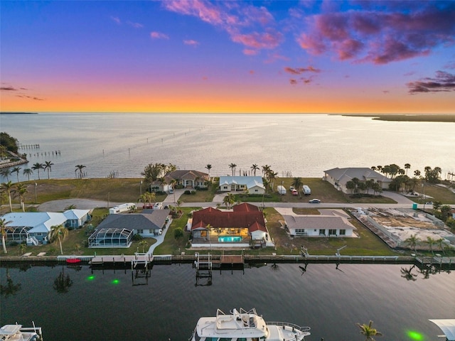 aerial view at dusk with a water view