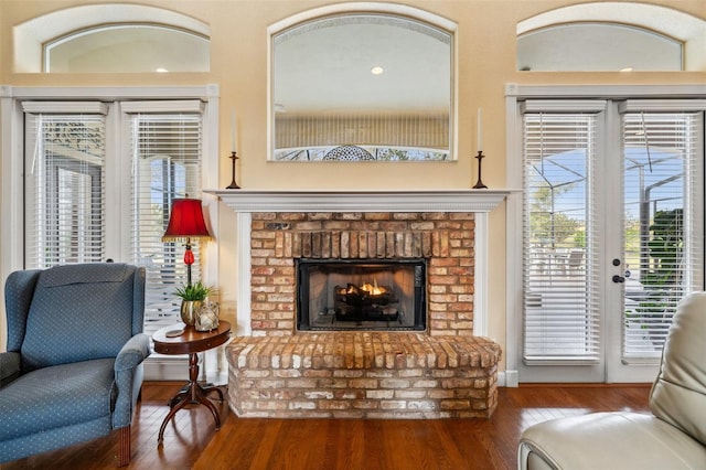 living area featuring hardwood / wood-style flooring and a fireplace