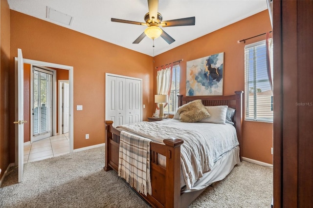 carpeted bedroom with a closet and ceiling fan