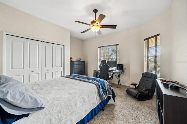 bedroom with carpet floors, ceiling fan, and a closet