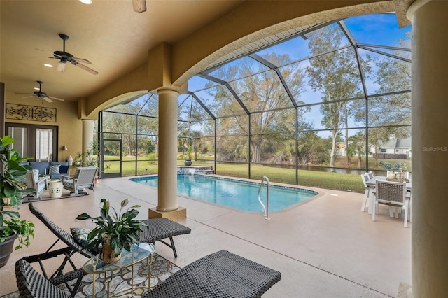 view of swimming pool featuring a patio, a lanai, and ceiling fan