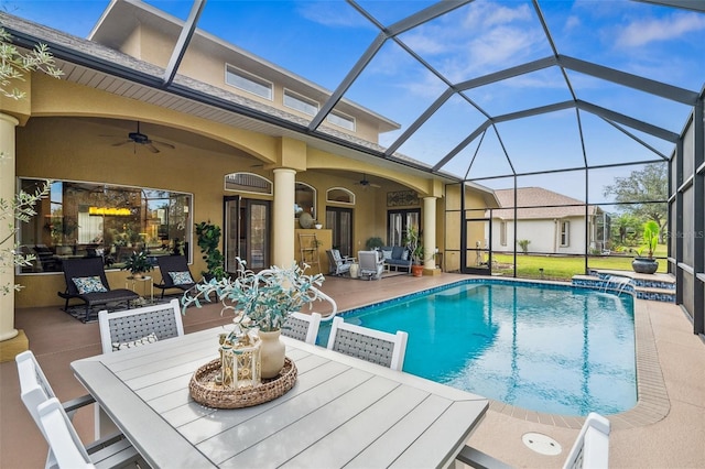 view of swimming pool featuring a lanai, a patio area, pool water feature, and ceiling fan