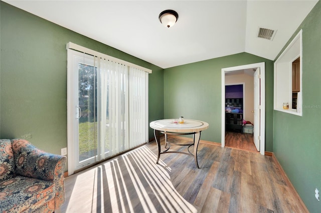 interior space with hardwood / wood-style flooring, vaulted ceiling, and plenty of natural light