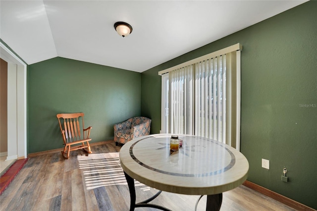 sitting room with hardwood / wood-style flooring and lofted ceiling