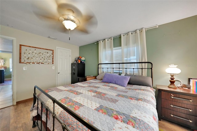 bedroom featuring ceiling fan and light hardwood / wood-style flooring