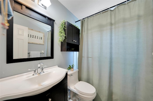 bathroom featuring vanity, vaulted ceiling, and toilet