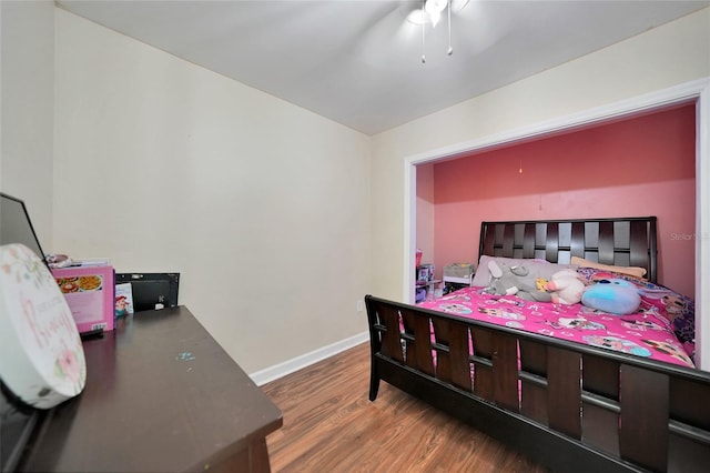 bedroom with ceiling fan and dark hardwood / wood-style floors