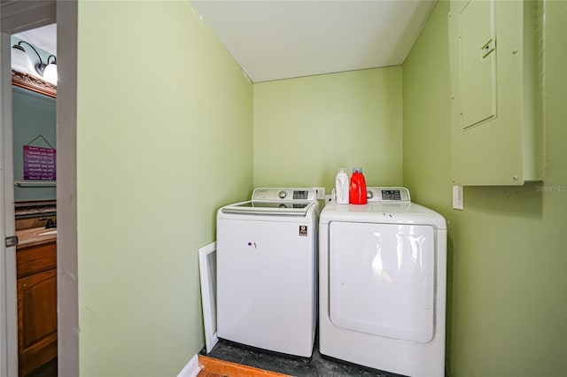 clothes washing area with electric panel and independent washer and dryer