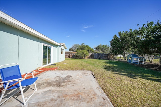 view of yard featuring a shed and a patio