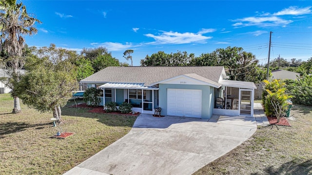 single story home with a front lawn, a garage, and a sunroom