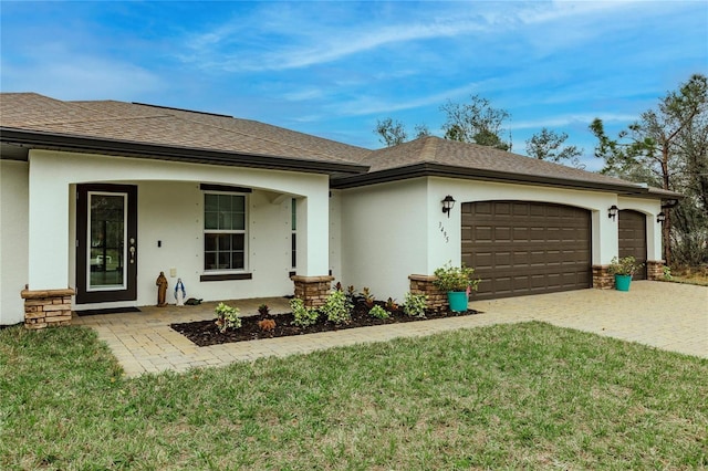 ranch-style house featuring a garage and a front yard