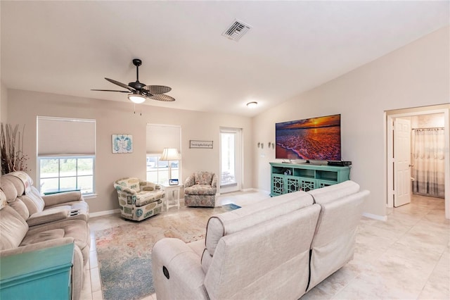 living room featuring ceiling fan and lofted ceiling