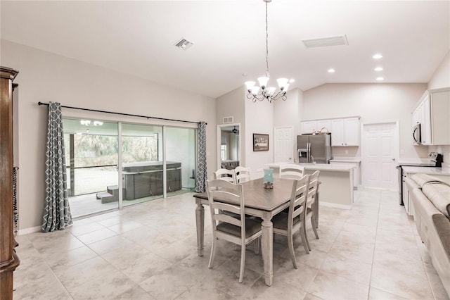 tiled dining area featuring an inviting chandelier and high vaulted ceiling