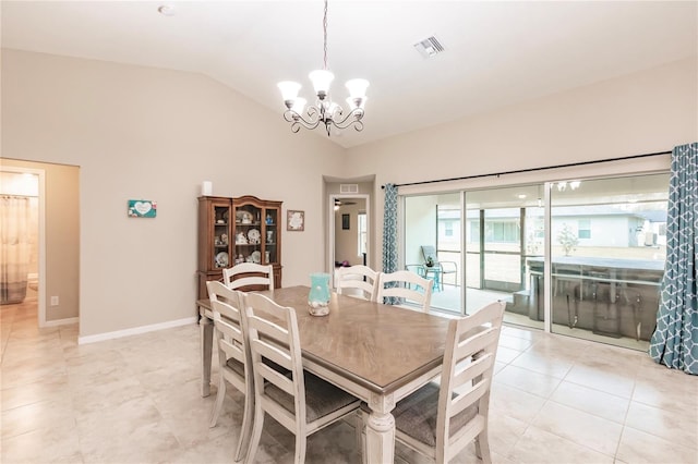 tiled dining area featuring an inviting chandelier and vaulted ceiling