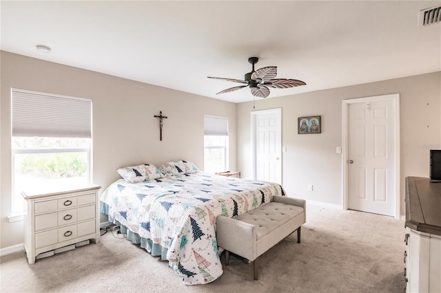 bedroom with light colored carpet and ceiling fan