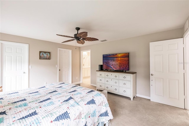 carpeted bedroom featuring ceiling fan and ensuite bath