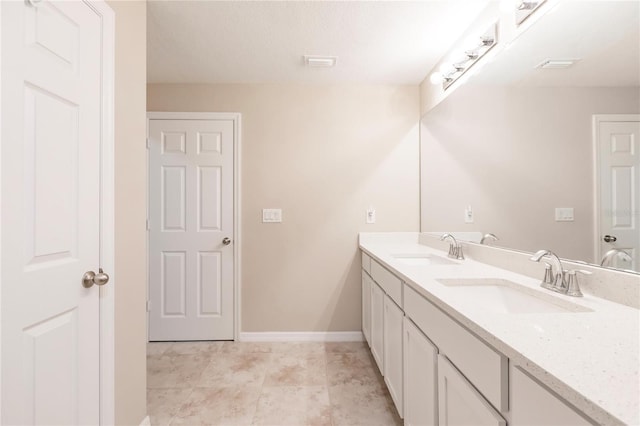 bathroom with vanity and a textured ceiling