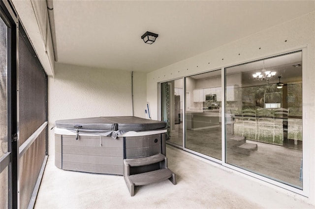 sunroom featuring a chandelier