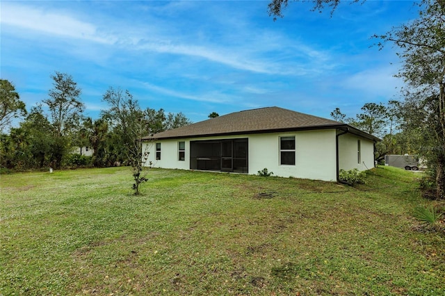 rear view of house featuring a lawn