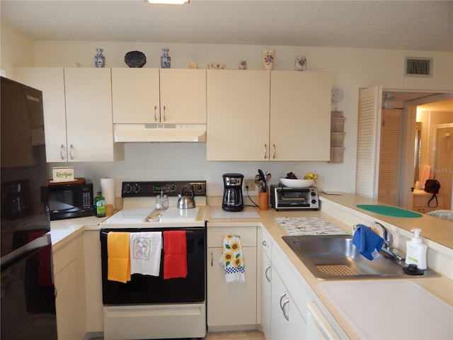 kitchen with sink, black appliances, and a textured ceiling