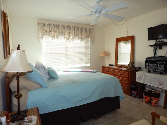 bedroom with ceiling fan and tile patterned floors