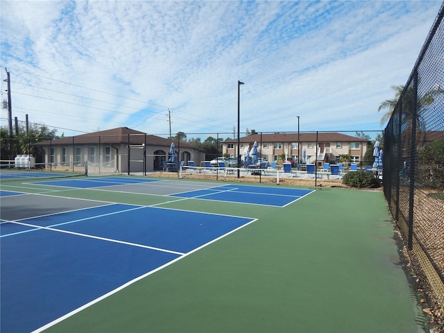 view of tennis court featuring basketball hoop