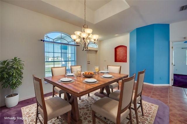 tiled dining space with lofted ceiling and a notable chandelier