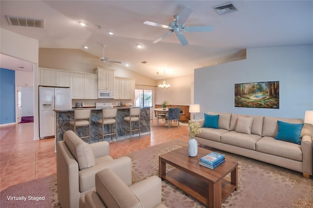 tiled living room featuring ceiling fan with notable chandelier and high vaulted ceiling