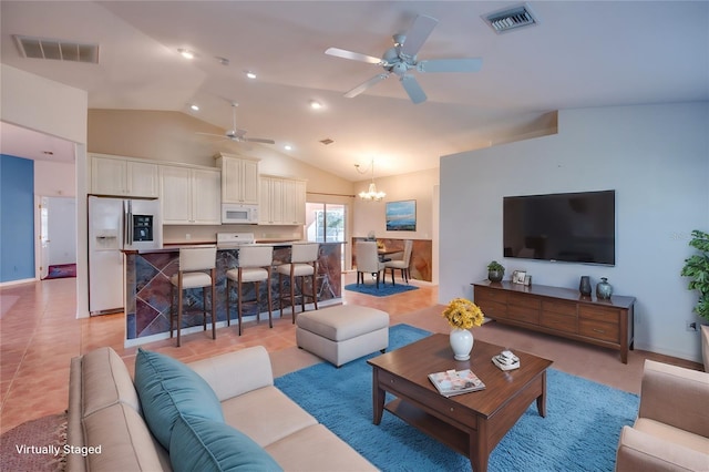 living room with light tile patterned flooring, lofted ceiling, and ceiling fan with notable chandelier