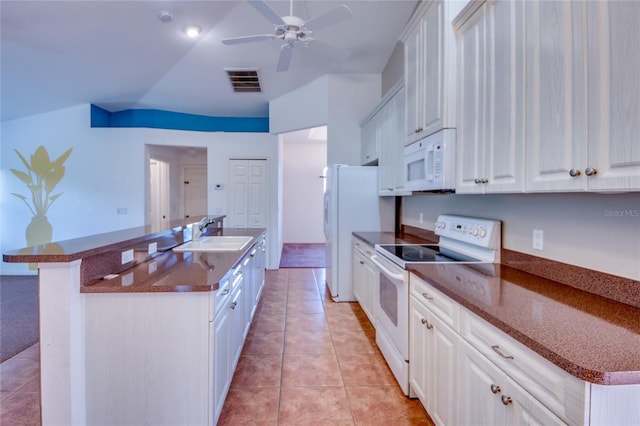 kitchen with vaulted ceiling, sink, white cabinets, and white appliances