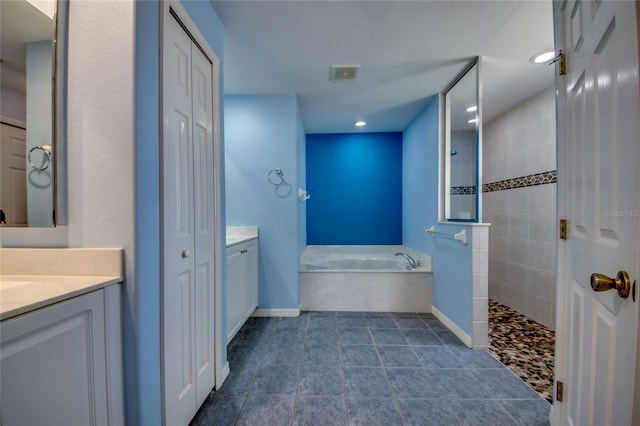 bathroom featuring vanity and shower with separate bathtub