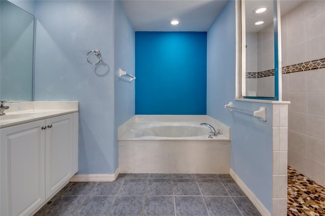 bathroom with vanity and independent shower and bath