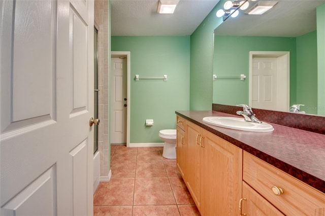 full bathroom featuring tile patterned floors, toilet, shower / bath combination with glass door, a textured ceiling, and vanity