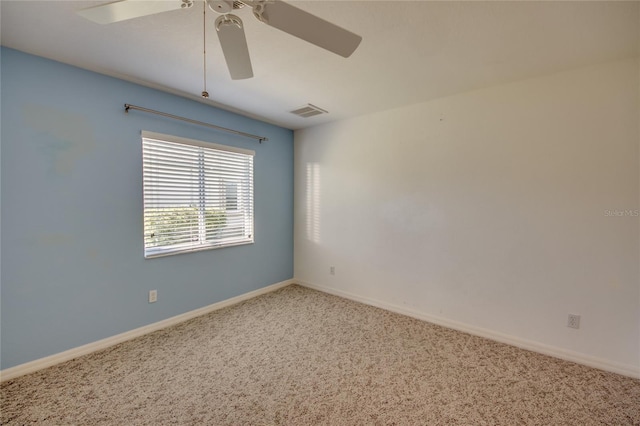 empty room featuring ceiling fan and carpet