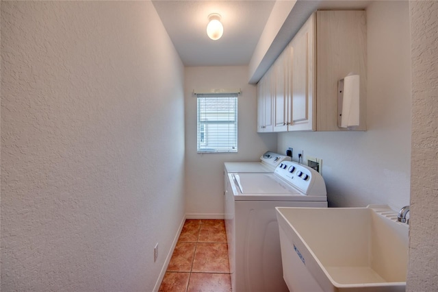 laundry room featuring cabinets, sink, washing machine and dryer, and light tile patterned floors