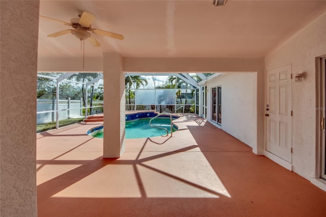 view of pool with a lanai, ceiling fan, and a patio area