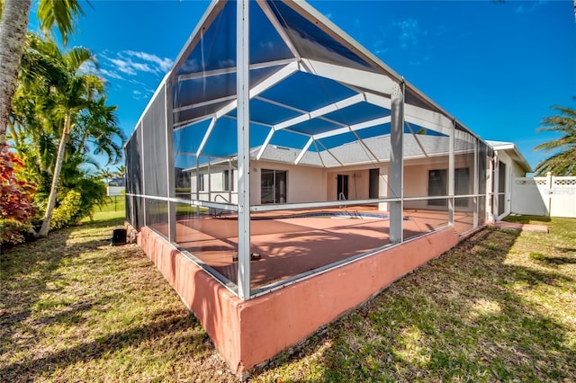 view of property exterior with a yard, a lanai, and a swimming pool