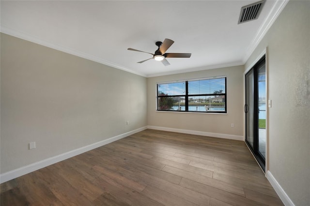 empty room with crown molding, ceiling fan, and hardwood / wood-style floors