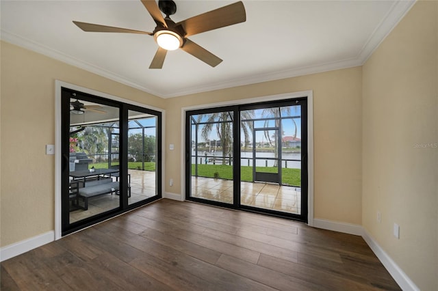 spare room with a water view, dark hardwood / wood-style floors, and crown molding