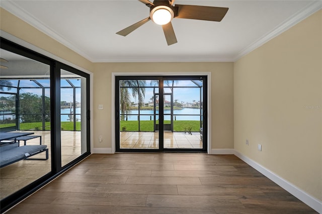 interior space with a water view, ornamental molding, wood-type flooring, and ceiling fan