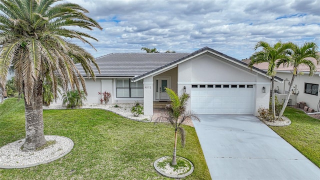 ranch-style house featuring a garage and a front yard