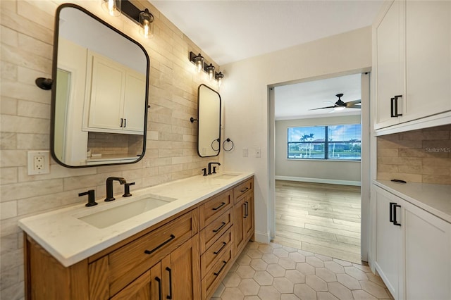 bathroom with ceiling fan, vanity, tile patterned flooring, and decorative backsplash