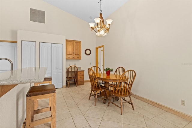 dining space featuring sink, high vaulted ceiling, a chandelier, and light tile patterned flooring