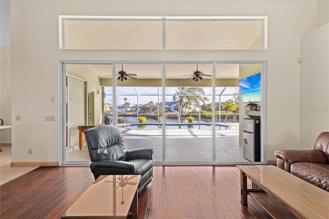 living room with ceiling fan and hardwood / wood-style floors