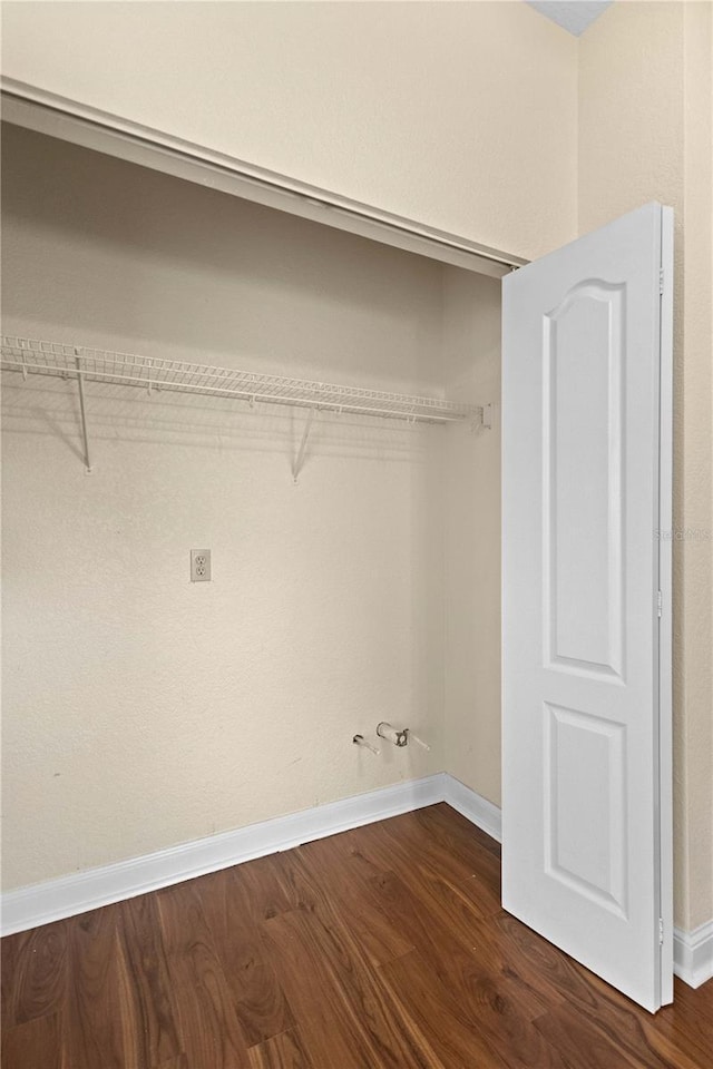 clothes washing area featuring dark hardwood / wood-style floors