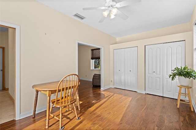 dining space with hardwood / wood-style floors and ceiling fan