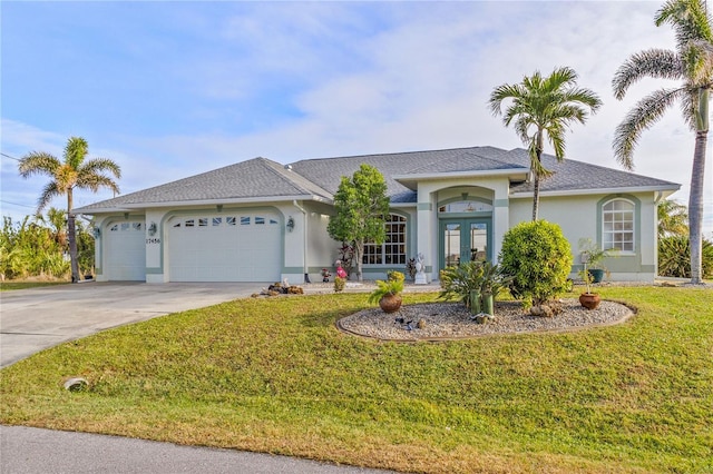 ranch-style home featuring a garage, a front yard, and french doors