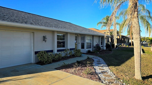 view of front facade with a garage and a front lawn