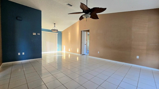 tiled empty room featuring ceiling fan and lofted ceiling