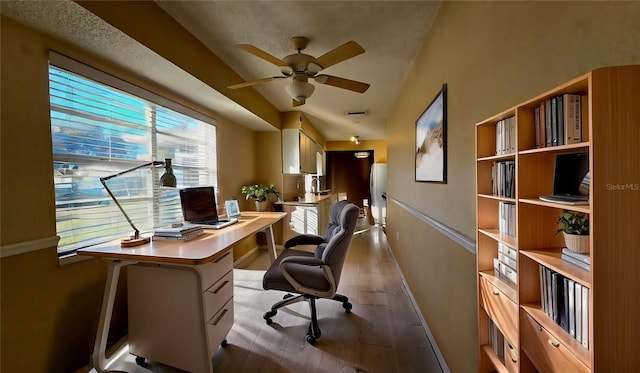 home office featuring ceiling fan and light wood-type flooring